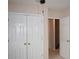 Hallway with closet doors adjacent to an open door at 1120 Lake Lucerne Rd, Lilburn, GA 30047