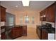 Kitchen boasts granite counters, dark wood cabinetry, stainless appliances, and a sunlit breakfast nook, perfect for modern living at 1120 Lake Lucerne Rd, Lilburn, GA 30047