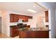 Kitchen with granite countertops, wooden cabinets, and stainless steel sink, offering a blend of style and functionality at 1120 Lake Lucerne Rd, Lilburn, GA 30047