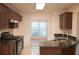 Spacious kitchen featuring stone countertops, wooden cabinets, and modern appliances at 1120 Lake Lucerne Rd, Lilburn, GA 30047