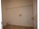Laundry room offers tile flooring and a storage rack, combining practicality with a simple design for everyday convenience at 1120 Lake Lucerne Rd, Lilburn, GA 30047