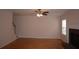 Spacious living room with hardwood floors, ceiling fan, and brick fireplace at 1120 Lake Lucerne Rd, Lilburn, GA 30047