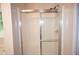 Clean bathroom shower with glass doors and a showerhead at 1120 Lake Lucerne Rd, Lilburn, GA 30047
