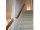 Carpeted stairs with a wood railing lead to the upper level of the home at 1120 Lake Lucerne Rd, Lilburn, GA 30047