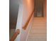 Carpeted stairs with a wood railing lead to the upper level of the home at 1120 Lake Lucerne Rd, Lilburn, GA 30047