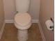 Toilet next to tile floor at 1120 Lake Lucerne Rd, Lilburn, GA 30047