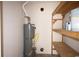 Utility room with water heater and shelving for storage at 1120 Lake Lucerne Rd, Lilburn, GA 30047
