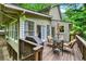 Back deck with patio table, seating, grill, and railing overlooking a beautiful wooded lot at 2253 Creekstone Ct, Marietta, GA 30062