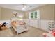 Bright bedroom with white wainscoting, neutral paint, and a window with curtains overlooking a wooded lot at 2253 Creekstone Ct, Marietta, GA 30062