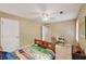Bedroom with neutral paint, carpet, ceiling fan, and desk with a window overlooking a wooded lot at 2253 Creekstone Ct, Marietta, GA 30062
