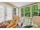 Bright breakfast nook featuring a glass table with fruit and large windows overlooking a lush, green landscape at 2253 Creekstone Ct, Marietta, GA 30062
