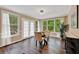 Cozy dining area with glass table and chairs, large windows, hardwood flooring, and French doors at 2253 Creekstone Ct, Marietta, GA 30062