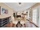 Dining area features glass table and chairs, hardwood floors, windows with curtains, and grey display cabinet at 2253 Creekstone Ct, Marietta, GA 30062