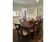 Cozy dining room with a dark wood table, comfortable chairs, and natural light from the nearby window at 2253 Creekstone Ct, Marietta, GA 30062