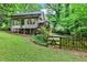 Back of home features a deck, large sunroom, and overlooks a sprawling backyard and wooded lot at 2253 Creekstone Ct, Marietta, GA 30062