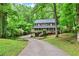 Charming two-story home featuring a welcoming front porch and surrounded by lush greenery, set back on a long driveway at 2253 Creekstone Ct, Marietta, GA 30062