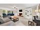 Open living room with a fireplace, built-in bookshelves, and ample natural light at 2253 Creekstone Ct, Marietta, GA 30062