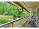 Spacious covered front porch with comfortable seating, offering serene views of the surrounding lush landscape at 2253 Creekstone Ct, Marietta, GA 30062