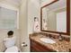 Cozy powder room with granite countertop and elegant fixtures at 2253 Creekstone Ct, Marietta, GA 30062