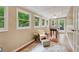 Bright sun room with multiple windows, hardwood floors, and foosball table overlooking backyard at 2253 Creekstone Ct, Marietta, GA 30062
