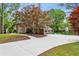 Brick home with a long driveway leading to a two-car garage, surrounded by mature trees at 230 Seamarsh Ct, Atlanta, GA 30328