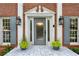 Elegant front entrance with a frosted glass door, sidelights, and decorative planters at 230 Seamarsh Ct, Atlanta, GA 30328