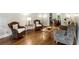 Inviting living room with hardwood floors, wicker furniture, and views into dining area at 230 Seamarsh Ct, Atlanta, GA 30328