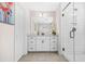 Bathroom with modern vanity, a framed mirror, and a glass-enclosed shower at 351 Boundless Ln, Canton, GA 30114