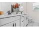 Bright bathroom featuring a double vanity with dark hardware and tile flooring at 351 Boundless Ln, Canton, GA 30114