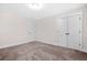 Empty bedroom with neutral walls and carpet, showcases a double door closet at 351 Boundless Ln, Canton, GA 30114