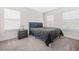Relaxing bedroom with ample natural light, carpet floors, and a navy blue bed at 351 Boundless Ln, Canton, GA 30114