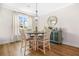 Charming dining area featuring hardwood floors, a round table, and ample natural light from the large window at 351 Boundless Ln, Canton, GA 30114