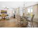 An open-concept dining area with views of the fireplace and sunlit backyard at 351 Boundless Ln, Canton, GA 30114