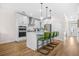 Well-appointed kitchen with stainless appliances, white cabinetry, a central island, and modern pendant lighting at 351 Boundless Ln, Canton, GA 30114