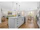 Open-concept kitchen with a large island, stainless steel appliances, and seamless connection to the living area at 351 Boundless Ln, Canton, GA 30114