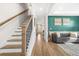 Spacious living room with stylish decor, hardwood floors, a gray sofa, and a staircase to the upper level at 351 Boundless Ln, Canton, GA 30114