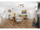 Cozy living room with a fireplace, stylish seating, and natural light flowing throughout the open layout at 351 Boundless Ln, Canton, GA 30114