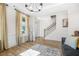 Elegant living room with staircase, a decorative rug, stylish furniture, and a large window with nice curtains at 351 Boundless Ln, Canton, GA 30114