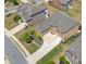 Aerial view of a brick home with an attached three-car garage, a large driveway, and mature trees at 5115 Edgebrook Dr, Cumming, GA 30040
