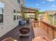 Back deck with seating and a grill, with a metal covering, and a stairway to the backyard at 5115 Edgebrook Dr, Cumming, GA 30040