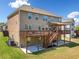 Exterior home view showing the two-story deck, a large grassy area, and surrounding landscape at 5115 Edgebrook Dr, Cumming, GA 30040