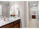Well-lit bathroom features a marble countertop with double sinks and updated fixtures at 5115 Edgebrook Dr, Cumming, GA 30040