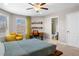 Bright bedroom with stylish decor, including a decorative ceiling fan and natural light at 5115 Edgebrook Dr, Cumming, GA 30040