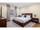 Comfortable bedroom with hardwood floors, an area rug, a queen size bed, side tables, and large window at 5115 Edgebrook Dr, Cumming, GA 30040