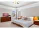 Expansive primary bedroom featuring a tray ceiling and large windows with natural light at 5115 Edgebrook Dr, Cumming, GA 30040
