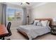 Bedroom with a bed in front of a window with gray curtains and a desk with office chair at 5115 Edgebrook Dr, Cumming, GA 30040