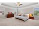 Bright bedroom featuring tray ceilings, carpet floors, and a modern bed at 5115 Edgebrook Dr, Cumming, GA 30040
