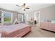 Bright bedroom with a pink bed, natural light, and access to an en-suite bathroom at 5115 Edgebrook Dr, Cumming, GA 30040