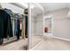 Walk-in closet with mirror, carpeted floor, and wire shelving for optimal storage and organization at 5115 Edgebrook Dr, Cumming, GA 30040