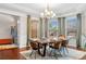 Bright dining room with wainscoting, big windows, and views into the living area at 5115 Edgebrook Dr, Cumming, GA 30040